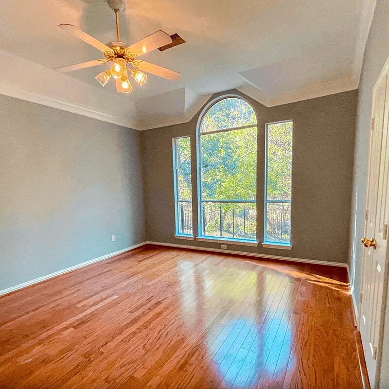 Empty room with wooden floor and window.