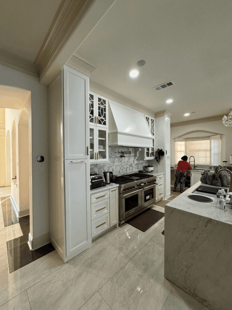 Modern kitchen with person near sink.