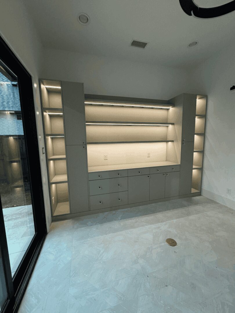 Built-in shelves with soft lighting in room.