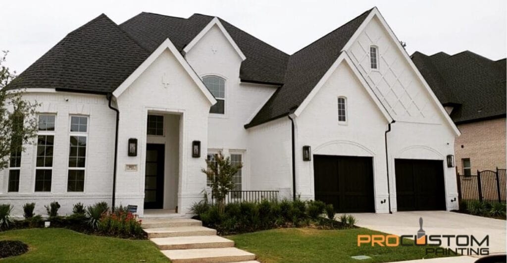 Modern white house with black roof shingles.