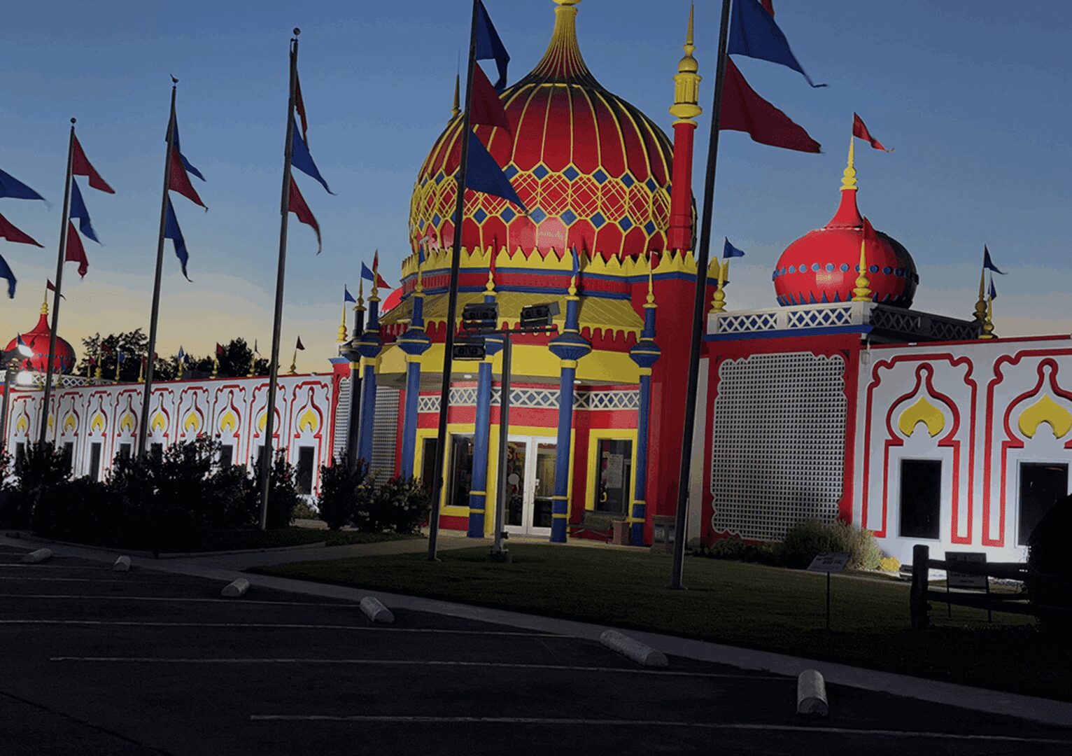 Colorful building with flags at dusk.