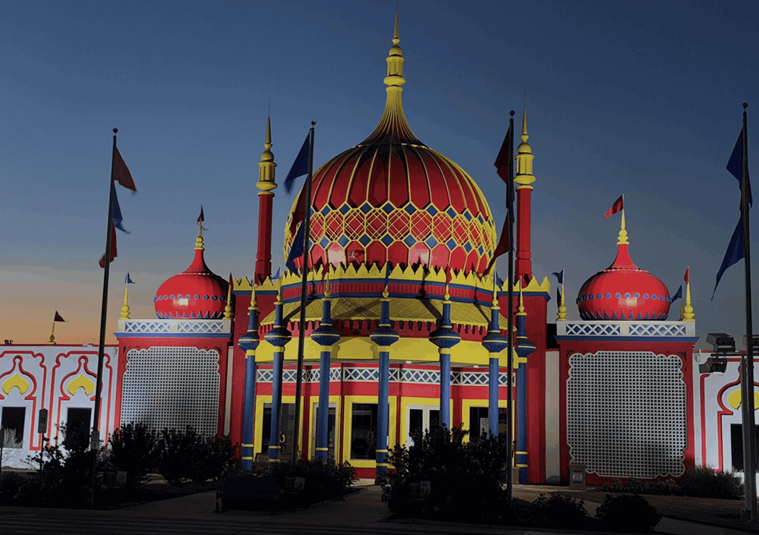 Colorful illuminated building with domes at night.
